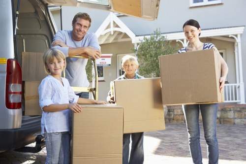 Mover wearing PPE while carrying furniture through a property