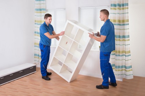 Professional movers loading furniture for urgent removal service