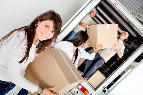 Professional movers packing furniture for a home move