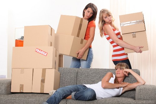 Removal team carrying boxes in a flat move